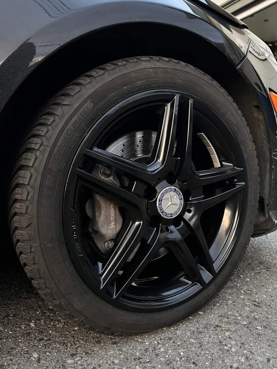 Close-up detail of a gloss black powder coated AMG wheel installed on a Mercedes-Benz daily driver in North Vancouver