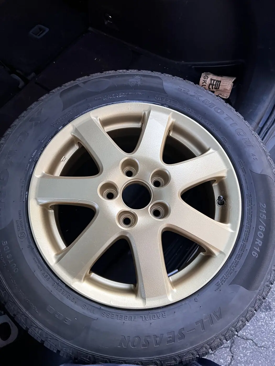 Champagne gold powder coated alloy wheel mounted on a tire and balanced, ready to install on customer's vehicle